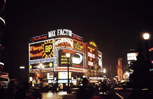 Neon light advert at night, Piccadilly Circus, London, England, Great Britain Christmas 1959