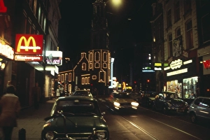 Neon lights in the city centre of Amsterdam at night, Netherlands 1970s 1980s, Macdonalds fast food restaurant