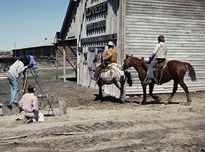 Nevada City historic ghost town, Montana, USA TV video team films two cowboys on horseback