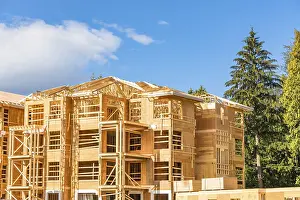 New apartment building under construction with two trunks of timber stored on side