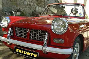 A very nice classic, a red Triumph Herald convertible
