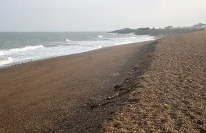 North Sea coastline shingle ridge on beach bar at East Lane