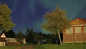 Northern lights (aurora borealis) over holiday homes