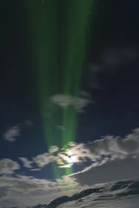 Northern Lights (Aurora borealis) over moonlit mountains on the long-distance hiking trail Kungsleden