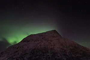 Northern Lights or Aurora Borealis over the mountain Vatterfjordtinden