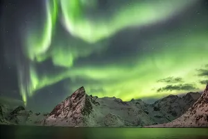 Northern Lights (Aurora Borealis) over mountains in winter