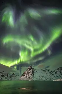 Northern Lights (Aurora Borealis) over mountains in winter