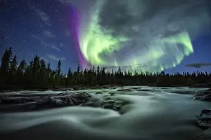Northern Lights or Aurora Borealis over River Gamajahka or Kamajakka