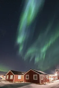 Northern Lights (Aurora Borealis) about Rorbuer huts in winter