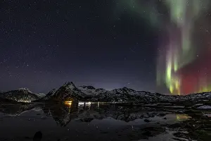Northern lights over fjord, steep mountains