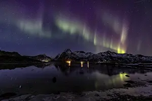 Northern lights over fjord, steep mountains