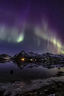 Northern lights over fjord, steep mountains