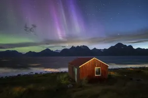 Northern Lights over a hut at the Lyngenfjord