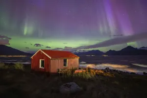 Northern Lights over a hut at the Lyngenfjord
