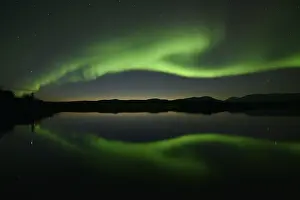 Northern lights reflected in a lake in the Abisko National Park