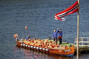 Norwegian flag, river cruise with tourists on an excursion boat