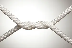 Nylon rope knot on a spot lit background