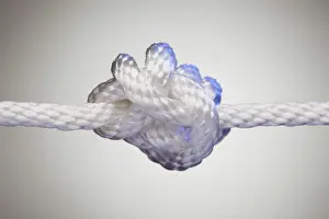 Nylon rope knot on a spot lit background