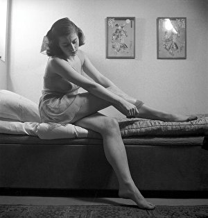Nylon stockings in the 1940s. A young woman is getting dressed in the moring