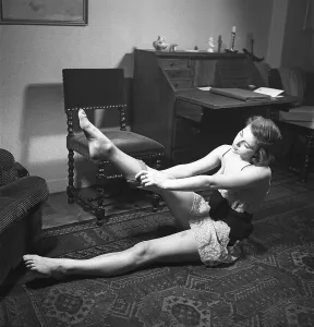 Nylon stockings in the 1940s. A young woman is getting dressed in the moring
