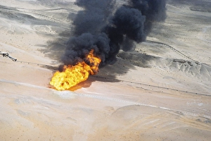 Oil industry in Ras Tanura area, Saudi Arabia, flare fire smoke in desert 1979, Asia
