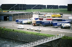 Oil storage tanks and vehicle freight containers on the quay, harbour of Rotterdam, Netherlands, around 1987