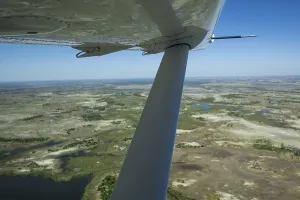 Okavango Delta aerial view with aeroplane wing