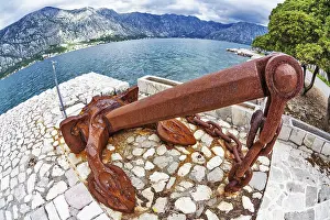 Old anchor on the waterfront on mountains background