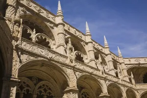 Old architectural building with arches and carved decorative sculptures in the inner courtyard at Jeronimos Monastery