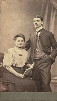 Old black and white photo, young couple in photo studio around 1910