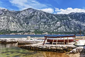 The old boat at the beach in the morning with the sea and mountains