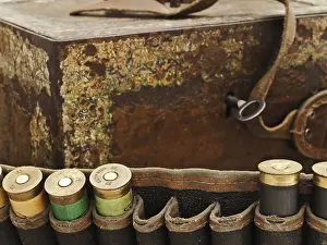 Some Old Cartridge For Hunting Rifle Against Vintage Rusty Chest