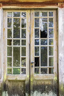 Old door with glass part on an abandoned house
