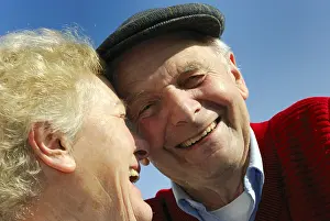 Old love, laughing grandfather and grandmother in front of a blue sky