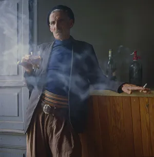 Old man drinks and smokes