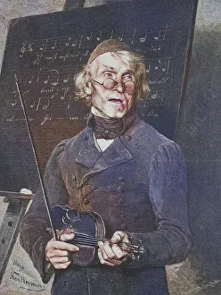 Old music teacher with violin standing in front of a table with sheet music