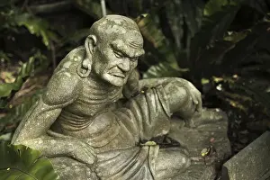 Old ruined Arhat Kanakbharadvaja statue in forest