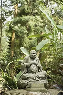 Old ruined Arhat Kanakbharadvaja statue in forest