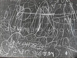 Old school blackboard with lots of scribbling on the blackboard surface