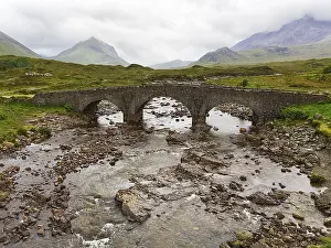 Old stone bridge Sligachan Bridge in front of Cuillin Hills mountains