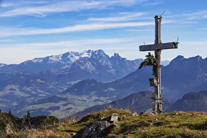 Old summit cross on the Schwarzer Berg with a view of the Lammertal valley and Dachstein massif