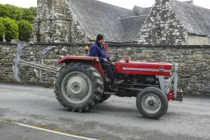 Category Oldtimer Prints: Old tractor Massey Ferguson 140 in front of church and chapel Sainte Nonne