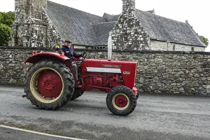 Old tractor Mc Cormick International 523 in front of church and chapel Sainte Nonne