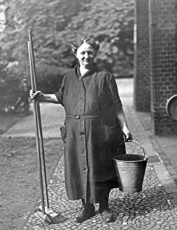 Old woman with bucket and broom