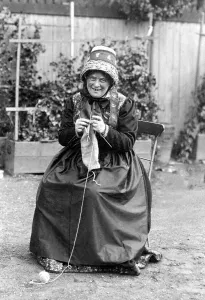 Old Woman knitting in Traditional Costume