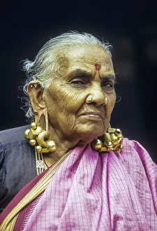 An old women wearing Thandatti massive ear ring to lengthen her ear lobes
