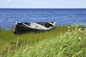 Old wooden fishing boat on the lake bank in north Russia