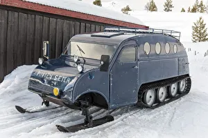 Oldtimer, Auto Neige, Bombardier snowmobile B12 with skis and chains in winter in the snow