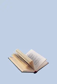 Open book in a blue cover on a blue background
