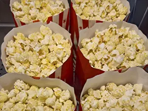 Several open large paper bags with snack popcorn puffed corn popping corn